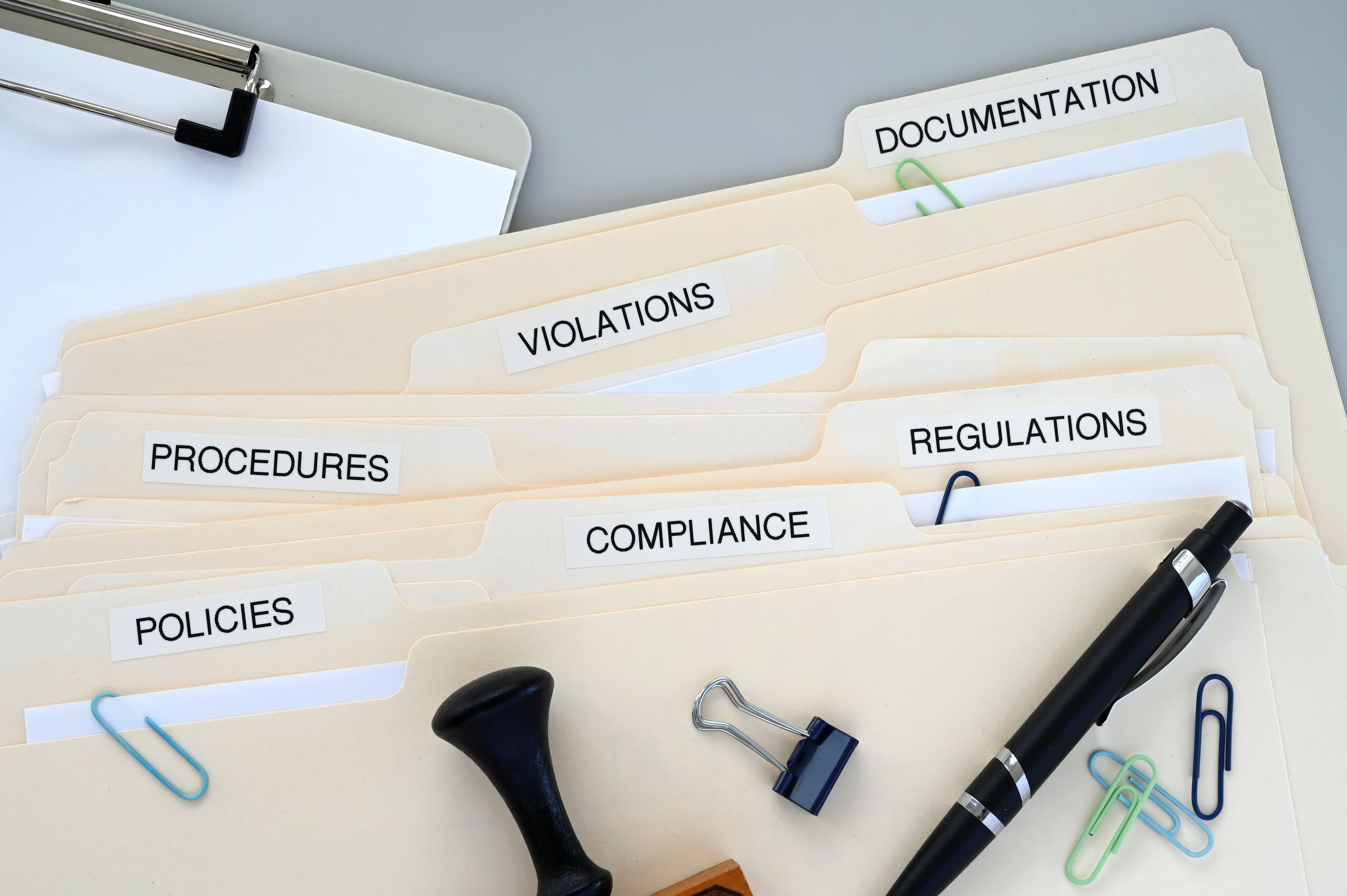 Policy and compliance documents under review at a desk.