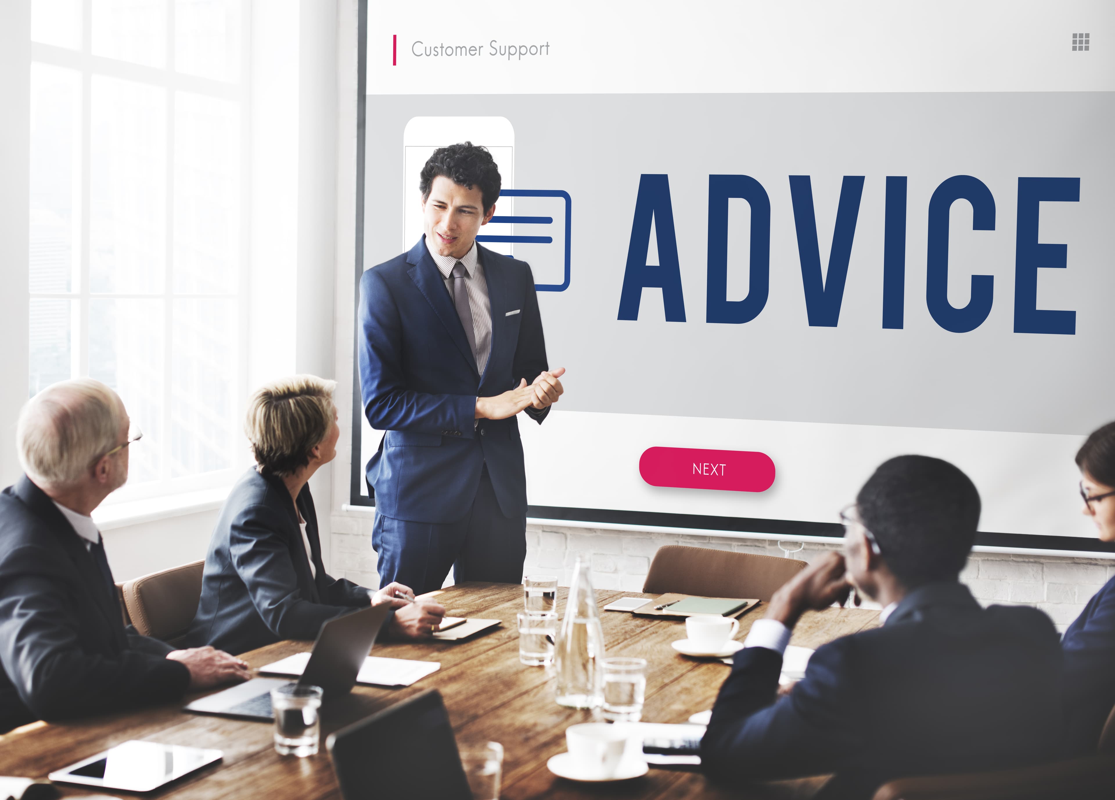 Independent advisory review with leadership around a meeting table.